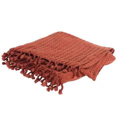 an orange blanket with tassels on the bottom and fringed edges is shown