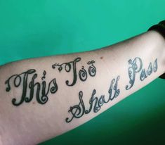 a person with a tattoo on their arm that says, this too shel pass