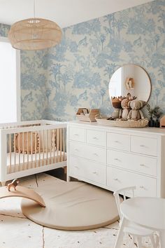 a baby's room with blue and white wallpaper