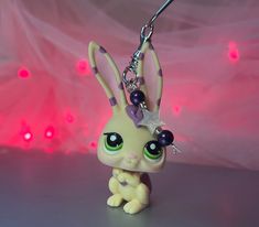 a little bunny keychain with a star on it's head and eyes