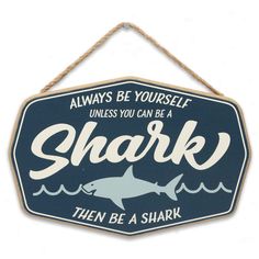 PRICES MAY VARY. Open Road Brands Official product: Live your best sharky life with this captivating and cool wall decor! Bursting with beachy charm, this sign is sure to make a splash. Fun Vintage Sign: With text that reads, "Always be yourself unless you can be a shark - then be a shark," a blue and white color palette, and a shark silhouette, this wall art is as fun as can be. Material: This eye-catching decor is made of lightweight, yet durable MDF, and it features a rope for quick and easy Shark Nursery Theme, Shark Nursery, Nautical Room Decor, Shark Sign, Shark Room, Underwater Room, Coastal Chic Decor, Ocean Room Decor, Shark Decor