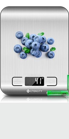 an electronic scale with blueberries on it