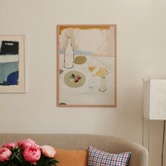 a living room filled with furniture and paintings on the wall above it's coffee table