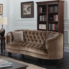 a living room filled with furniture and a book shelf