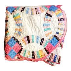 a colorful quilted blanket on top of a white surface