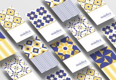 an array of blue, yellow and white cards with geometric designs on them that spell out the word happiness