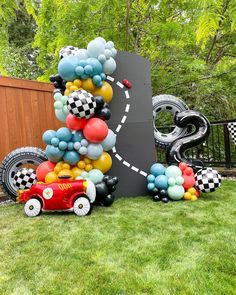 a birthday cake made out of balloons in the shape of a race car