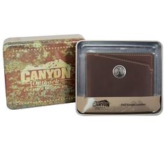 a brown leather wallet in a box with the label canyon on it's side