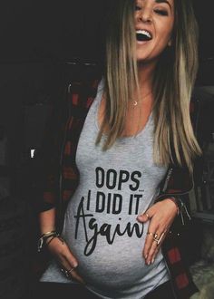 a woman laughing while wearing a shirt that says do's aid it again