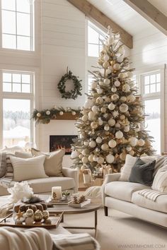 a living room with a christmas tree in the corner and couches on the other side