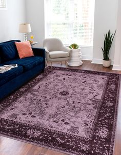 a living room filled with furniture and a purple rug