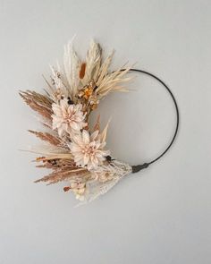 dried flowers are arranged on a black headband