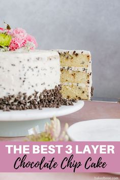 the best 3 layer chocolate chip cake with white frosting and pink flowers on top