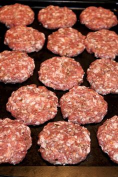 some hamburger patties are cooking on a grill