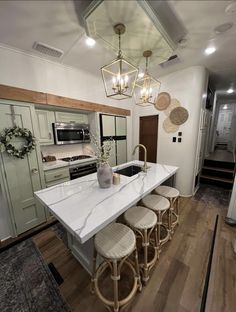 a kitchen island with four stools next to it