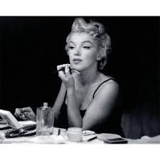 a black and white photo of a woman sitting at a table