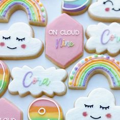 decorated cookies with rainbows, clouds and words that say on cloud nine are in front of each other