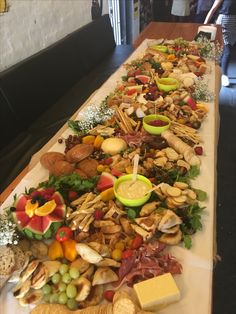 a long table filled with lots of different types of food on top of each other