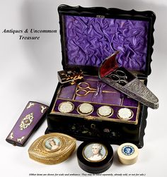 an antique and uncommon prestige box with various items in it, including a pair of scissors