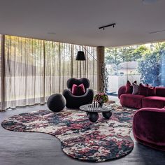 a living room filled with lots of purple furniture