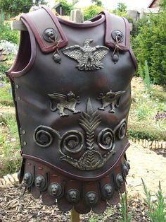 a large brown leather armor sitting on top of a wooden pole