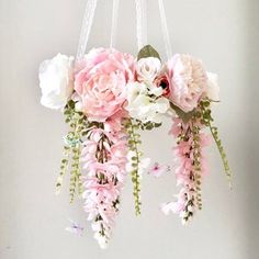 pink and white flowers are hanging from the ceiling