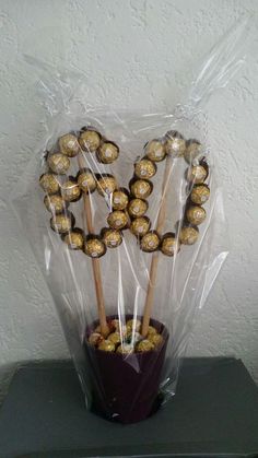 a bouquet of chocolate covered pretzels wrapped in cellophane and sitting on top of a table