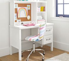 a white desk with a colorful chair in front of it and a window behind it