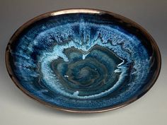 a blue bowl sitting on top of a table