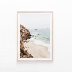 a framed photo hanging on the wall above a beach