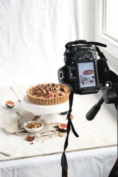 a camera attached to a tripod with food in the background