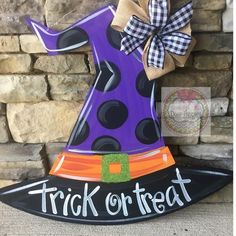 a trick or treat witch hat on top of a broom