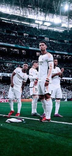 several soccer players are standing on the field