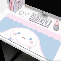 a computer desk with a mouse, keyboard and monitor on it's side table