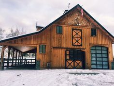 a large wooden building sitting on top of snow covered ground