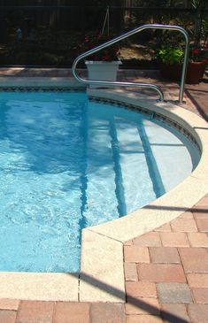 an empty swimming pool with steps leading up to it