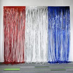 red, white and blue tinsel curtains in an office