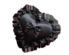 a black heart shaped pillow with a bow on the front and back of it's ruffled edges