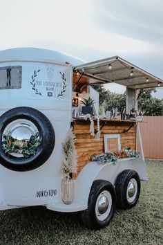 the food truck is decorated with greenery and decorations