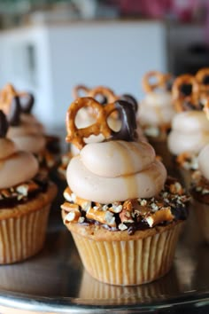 some cupcakes are decorated with pretzels and nuts