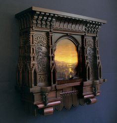 an intricately carved wooden shelf with a mirror on it