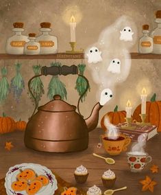 a tea pot and some cupcakes on a table with ghost candles in the background