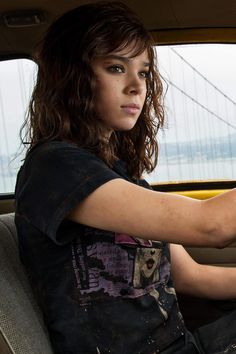 a woman sitting in the back seat of a car