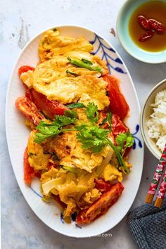 a plate of Vietnamese dinner omelet with tomatoes and onions Vietnamese Dinner, Eggs And Tomatoes, Asian Steak, Asian Steak Bites, Shrimp Toast, Sweet Onions, Stir Fry Dishes, Homemade Mayonnaise, Quick And Easy Appetizers