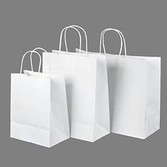 three white shopping bags with handles on each side and one in the middle, against a gray background