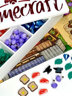 a box filled with lots of different colored candies next to a sign that says minecraft