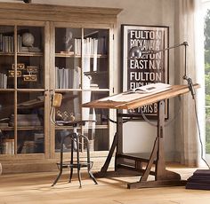 a living room filled with furniture and a fire place next to a book shelf on top of a hard wood floor