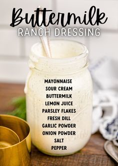 a mason jar filled with buttermik ranch dressing on top of a wooden table