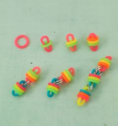 several different colored plastic objects on a white surface with the letters o and o spelled out