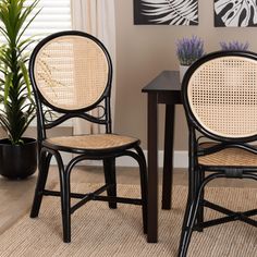 two chairs sitting next to each other on top of a rug